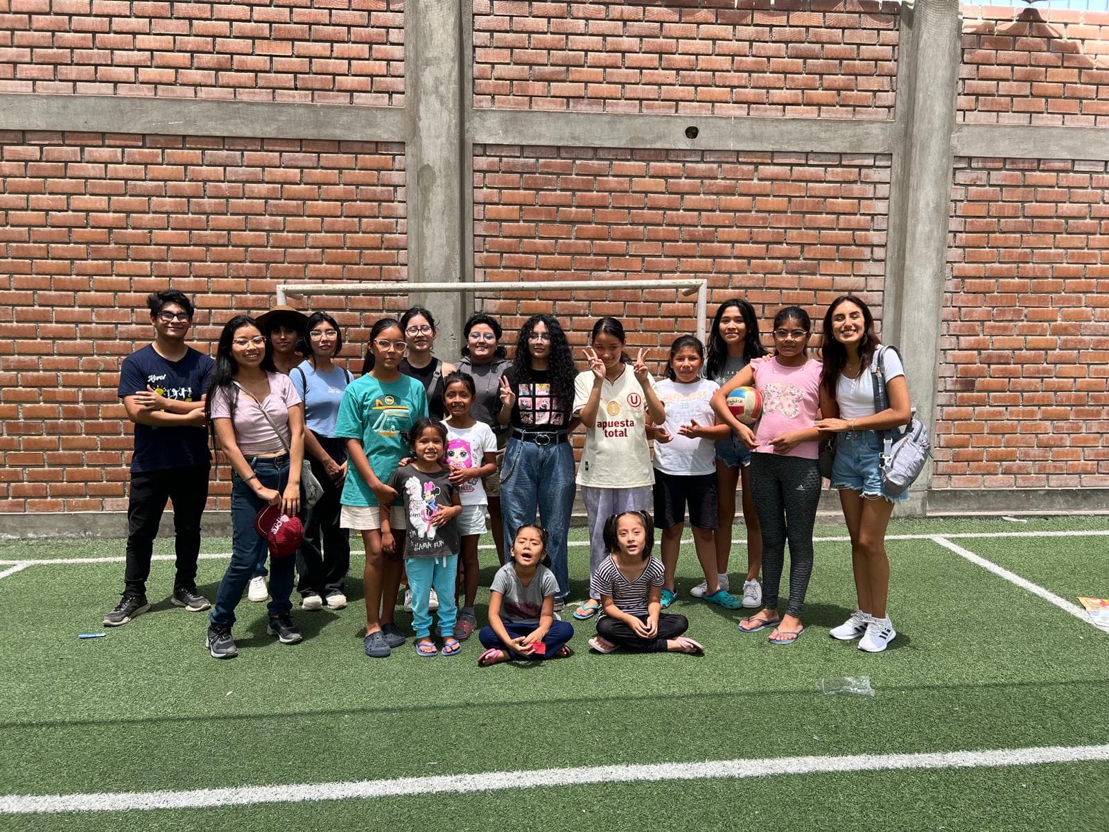 Youth community group gathered outdoors during a Kectil community project activity.